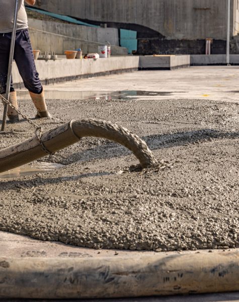 Construction worker pouring a wet concret Construction worker pouring a wet concret