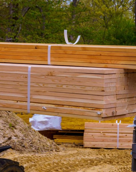 Lift truck moving a stack of 2 x 4 lumber studs at a small log processing Lift truck moving a stack of 2 x 4 lumber studs at a small log processing
