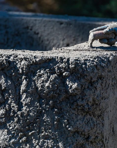 Pool Construction Worker Working With A Smoothing Trowel On Wet Concrete Pool Construction Worker Working With A Smoothing Trowel On Wet Concrete